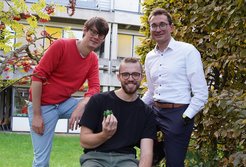 Georg Hochberg (left), Luca Schulz (centre), and Tobias Erb with a model of Rubisco.
