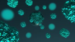 Blue glowing, spherical structures float in front of a dark, blurred background in the room.